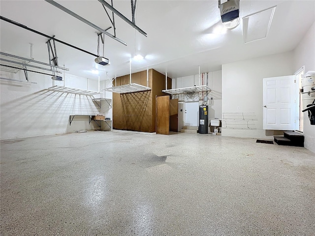 garage with a garage door opener and electric water heater