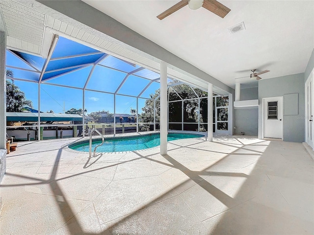 view of pool featuring a patio, ceiling fan, and glass enclosure