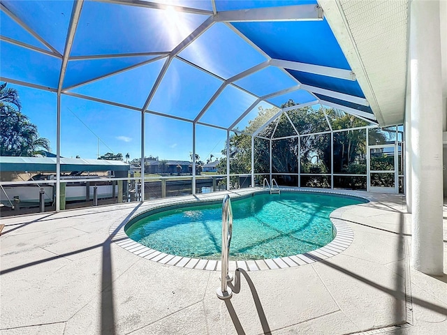 view of pool featuring a patio area and glass enclosure