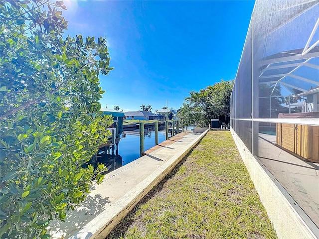 view of dock with glass enclosure and a water view