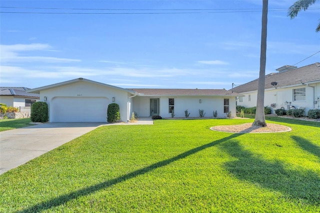 ranch-style house featuring a garage and a front lawn