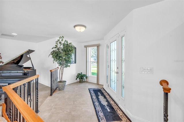 entrance foyer featuring light tile patterned flooring and french doors