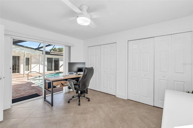 office area with light tile patterned floors and ceiling fan