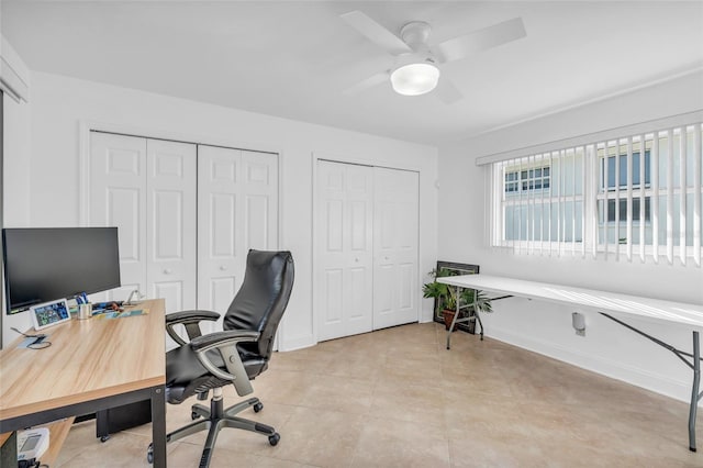 home office with ceiling fan and light tile patterned floors