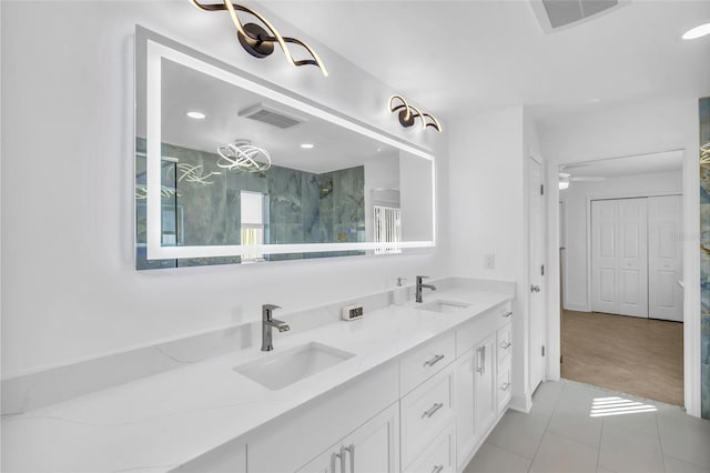 bathroom with vanity and tiled shower