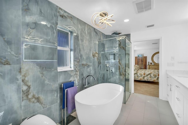 bathroom with tile walls, vanity, tile patterned flooring, and shower with separate bathtub