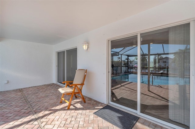 view of patio / terrace featuring glass enclosure