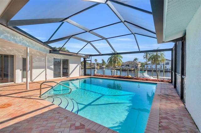 view of pool featuring a water view, a patio area, and glass enclosure