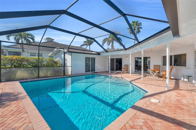 view of swimming pool featuring a lanai and a patio area