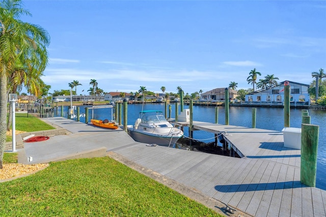 view of dock featuring a water view and a lawn