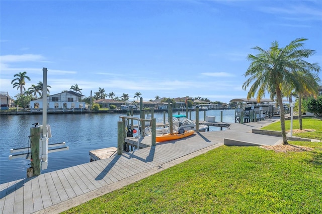 dock area with a yard and a water view