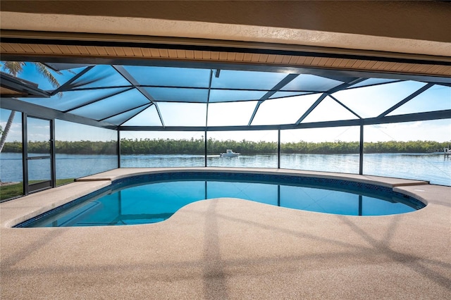 view of pool with glass enclosure and a water view