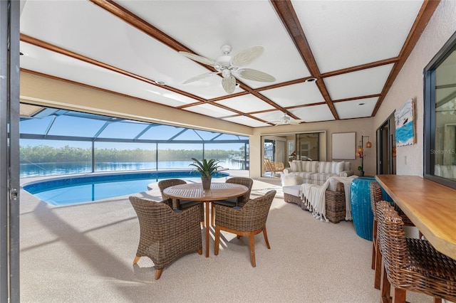 interior space featuring coffered ceiling, ceiling fan, and a water view