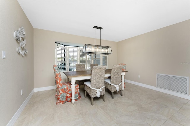 dining space featuring a notable chandelier