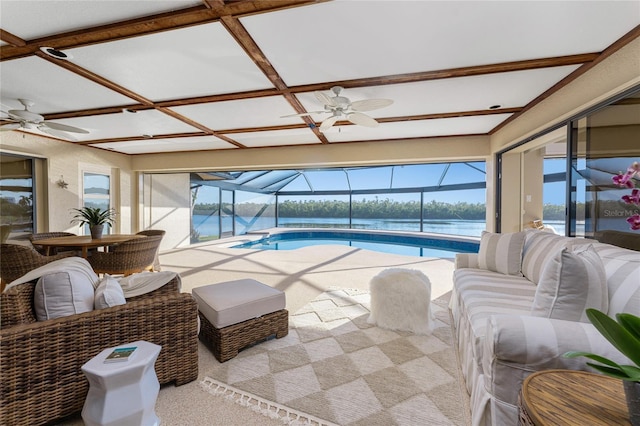 sunroom / solarium featuring coffered ceiling, a wealth of natural light, ceiling fan, and a water view