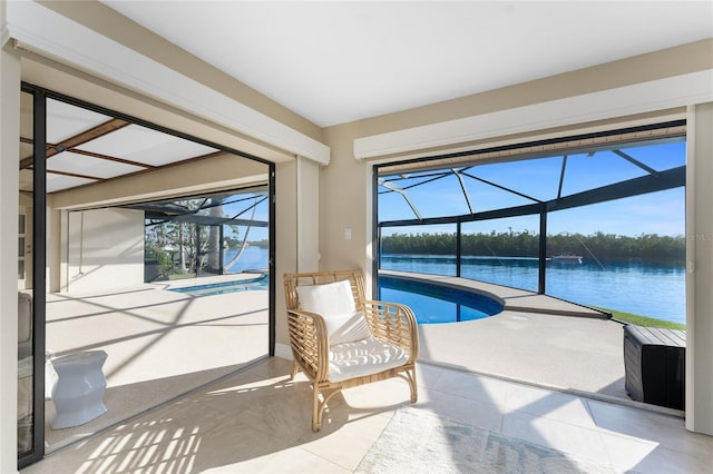 unfurnished sunroom featuring a pool and a water view