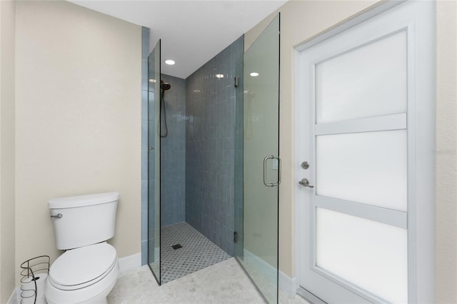 bathroom featuring tile patterned flooring, walk in shower, and toilet