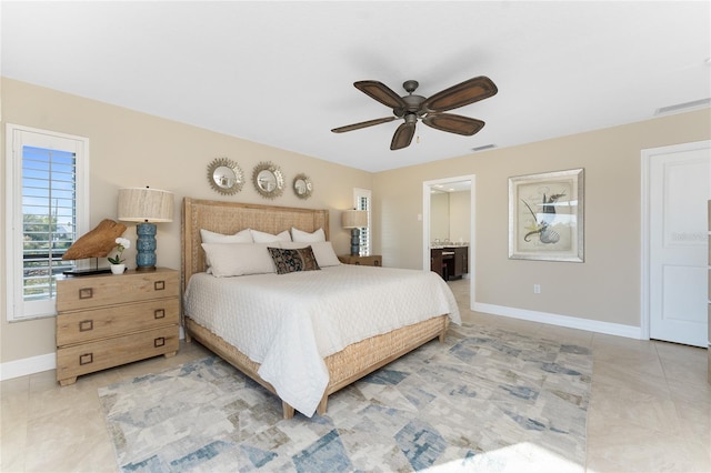 bedroom featuring ceiling fan, tile patterned flooring, and ensuite bath