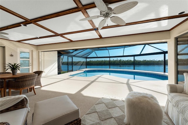 view of pool with a water view and ceiling fan