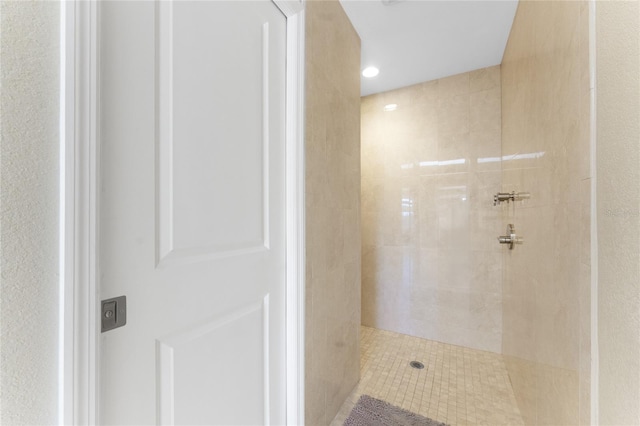 bathroom with a tile shower