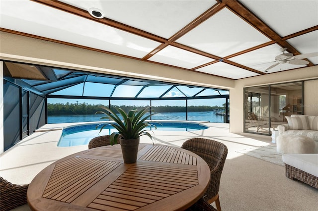 interior space with a water view and ceiling fan