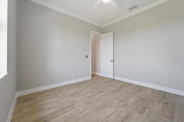 spare room with crown molding, ceiling fan, and light wood-type flooring