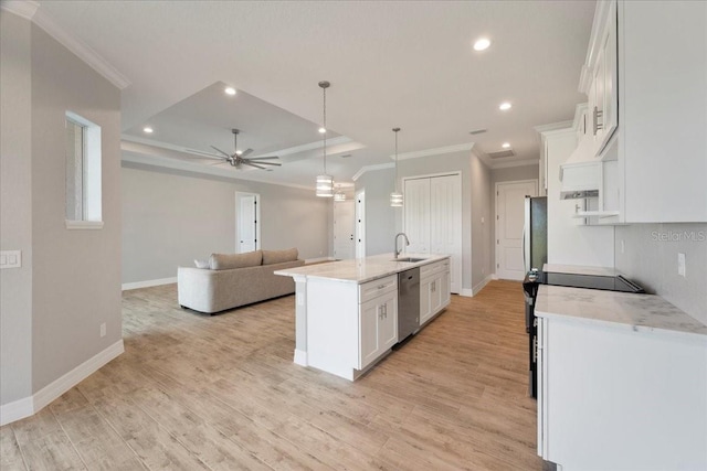 kitchen featuring light stone counters, decorative light fixtures, a center island with sink, stainless steel appliances, and white cabinets