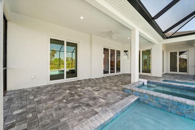 view of swimming pool featuring an in ground hot tub, ceiling fan, and a patio area