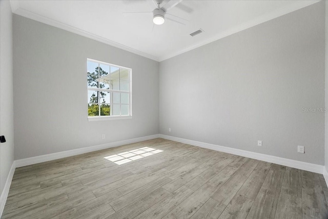 spare room with crown molding, ceiling fan, and light wood-type flooring