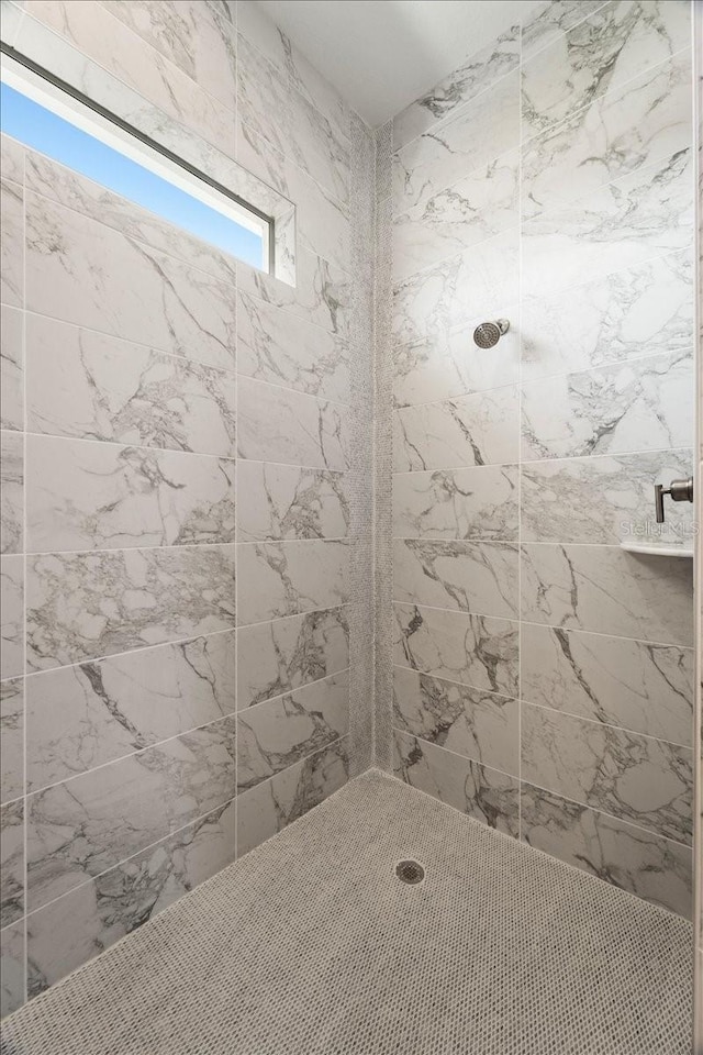 bathroom with a tile shower