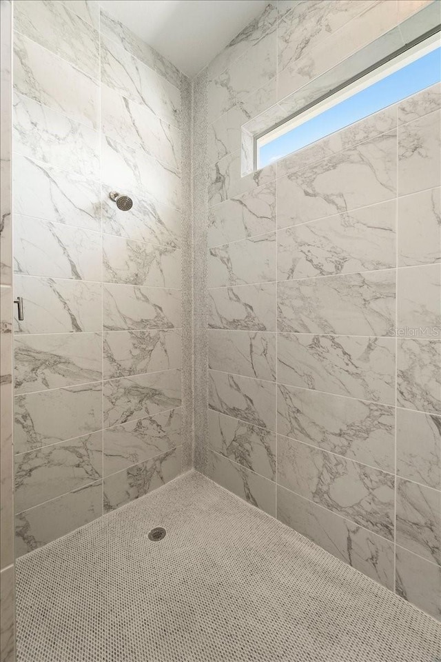 bathroom with a tile shower