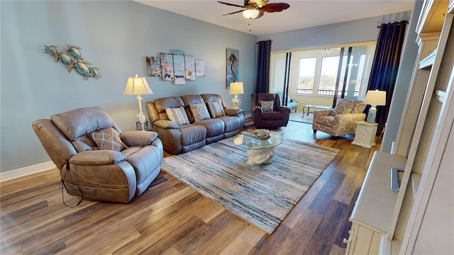 living room featuring dark hardwood / wood-style floors and ceiling fan