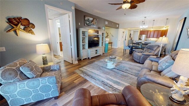 living room with wood-type flooring and ceiling fan