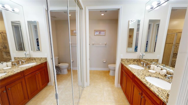 bathroom with tile patterned flooring, vanity, and toilet