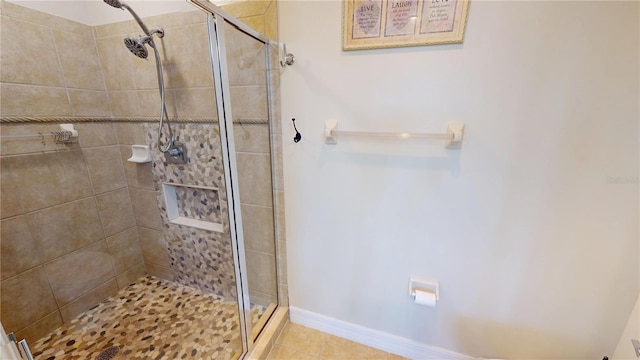 bathroom featuring tiled shower and tile patterned floors