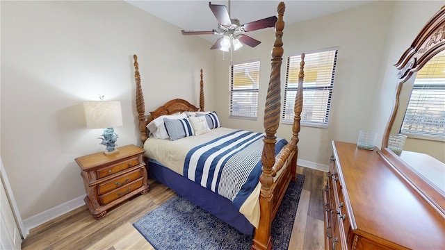 bedroom featuring multiple windows, ceiling fan, and light wood-type flooring