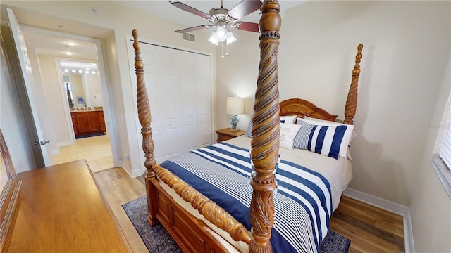 bedroom with light hardwood / wood-style flooring, a closet, and ceiling fan