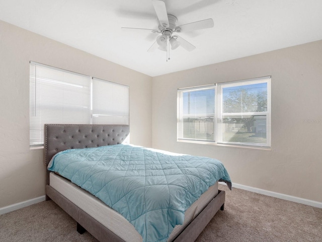 bedroom featuring ceiling fan and carpet