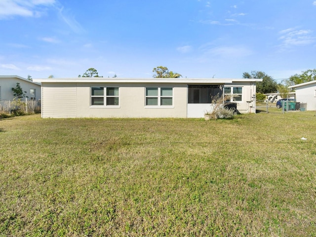 rear view of property with a yard