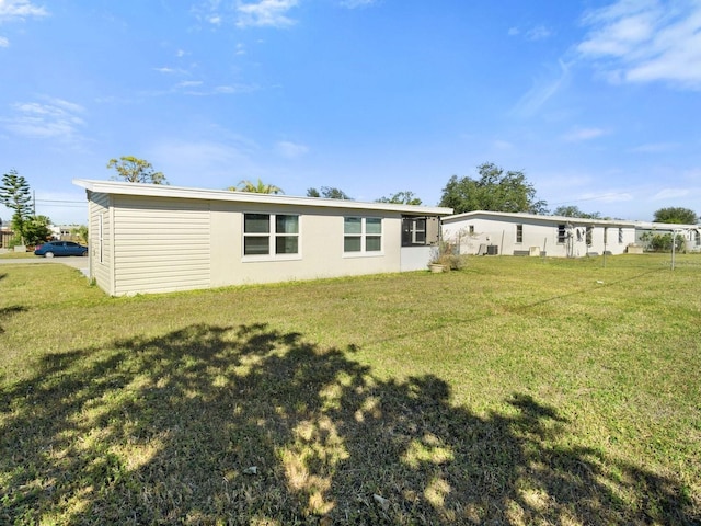 back of property with a lawn