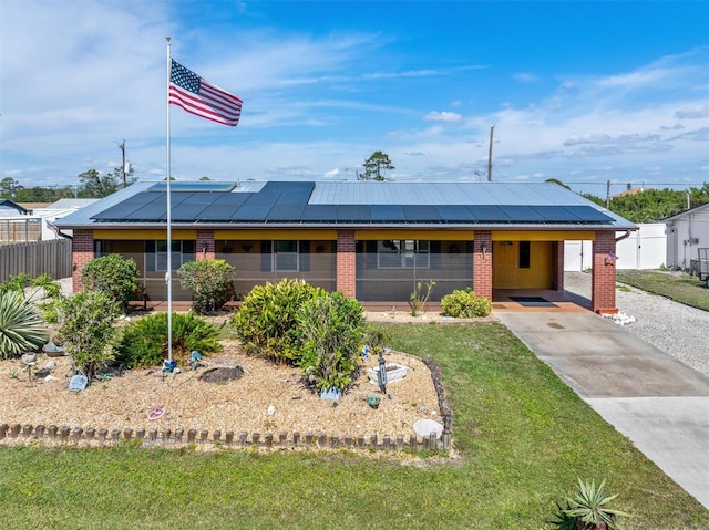 single story home with a front yard and a carport