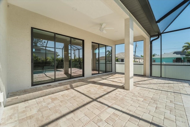 unfurnished sunroom featuring ceiling fan