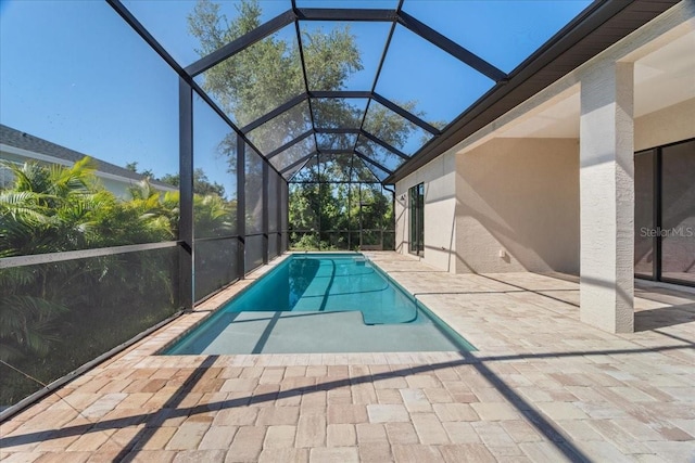 view of pool with a lanai and a patio area