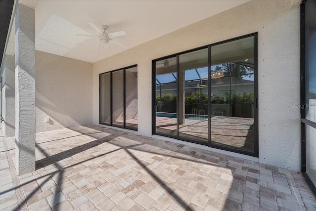 view of patio / terrace with a lanai and ceiling fan