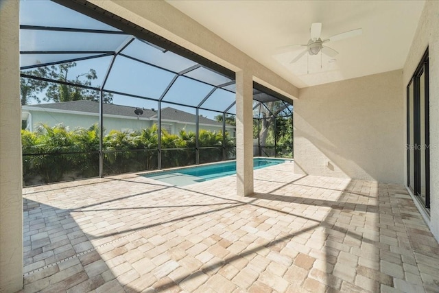 view of swimming pool featuring a lanai, a patio area, and ceiling fan