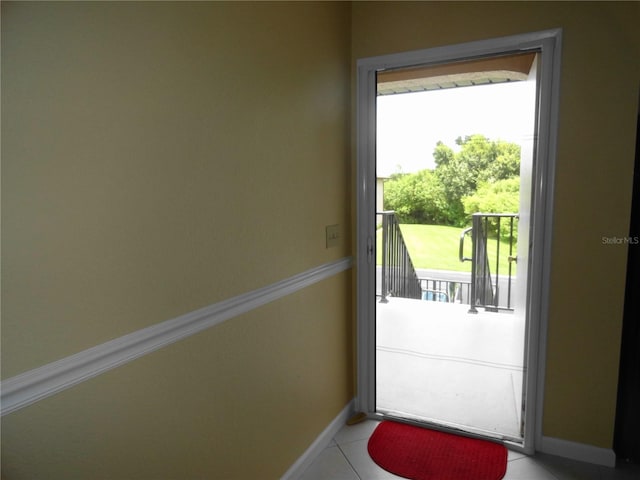 entryway with light tile patterned floors and plenty of natural light