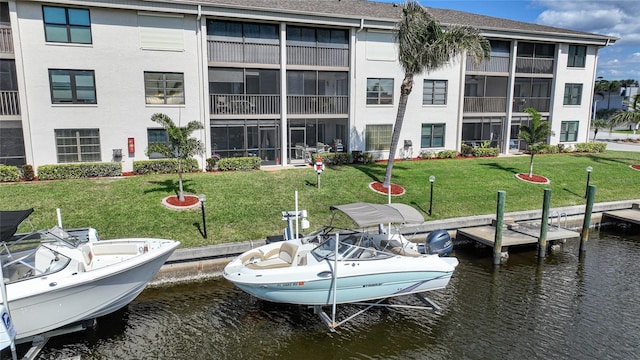 view of dock featuring a yard and a water view