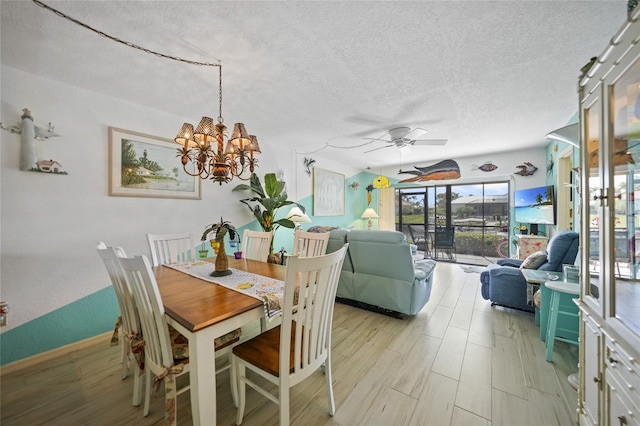 dining space with ceiling fan with notable chandelier, a textured ceiling, and light wood-type flooring