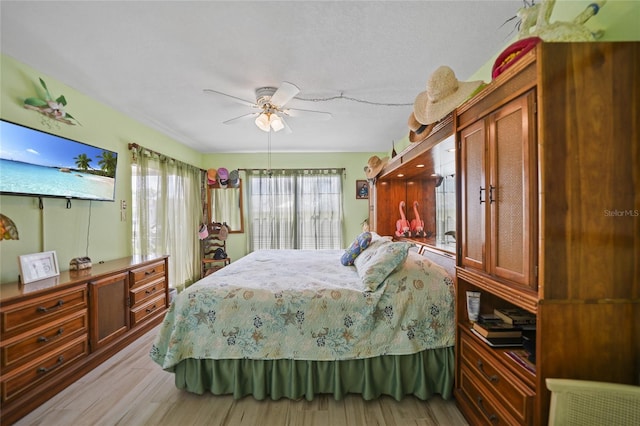 bedroom featuring ceiling fan and light hardwood / wood-style flooring