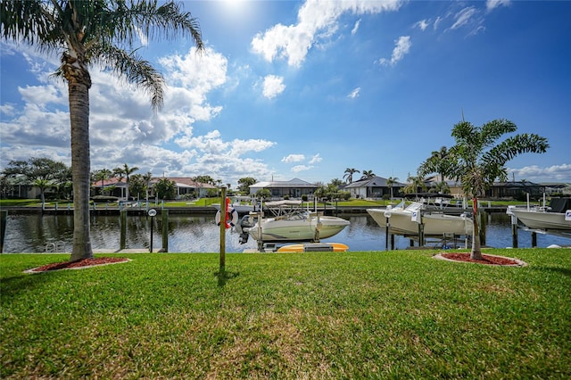 dock area featuring a water view and a yard